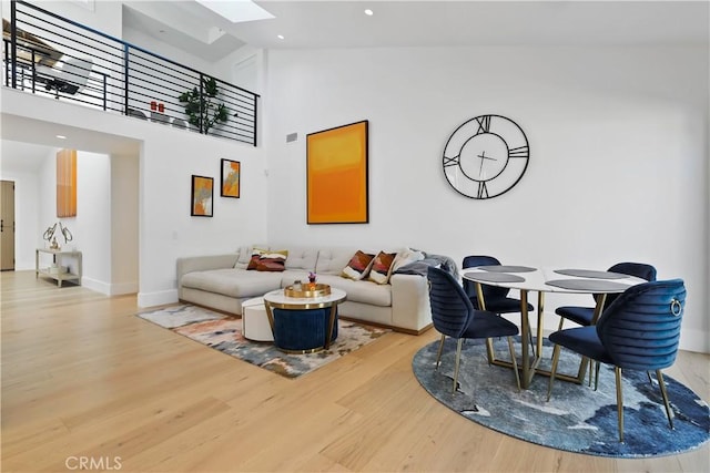 1954 Port Locksleigh Pl, Newport Beach, CA 92660 - living room featuring a skylight, wood finished floors, recessed lighting, baseboards, and high vaulted ceiling