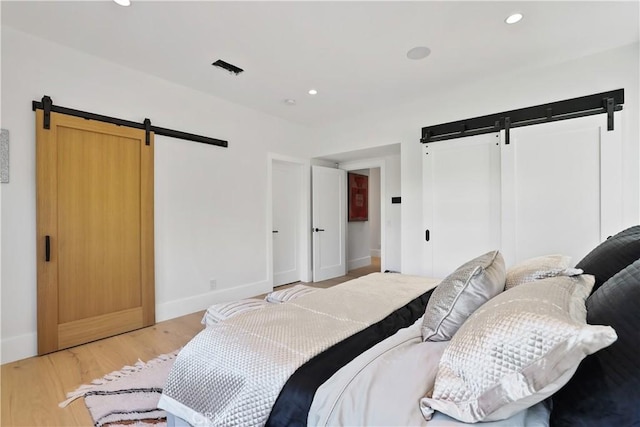 1954 Port Locksleigh Pl, Newport Beach, CA 92660 - bedroom featuring a barn door, light wood finished floors, baseboards, and recessed lighting