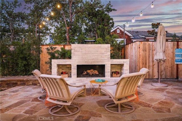 1954 Port Locksleigh Pl, Newport Beach, CA 92660 - patio terrace at dusk with an outdoor brick fireplace and a patio
