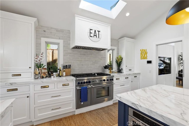 1954 Port Locksleigh Pl, Newport Beach, CA 92660 - kitchen featuring double oven range, a skylight, white cabinetry, lofted ceiling, and light stone countertops