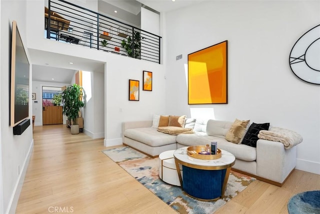 1954 Port Locksleigh Pl, Newport Beach, CA 92660 - living room featuring wood finished floors, baseboards, and a high ceiling