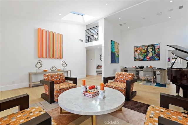 1954 Port Locksleigh Pl, Newport Beach, CA 92660 - living area with light wood-style floors, a skylight, a towering ceiling, baseboards, and recessed lighting