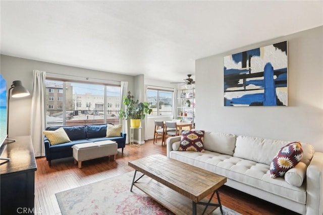 living room with wood finished floors and ceiling fan