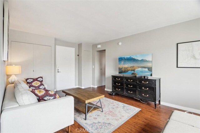 living area featuring wood finished floors and baseboards