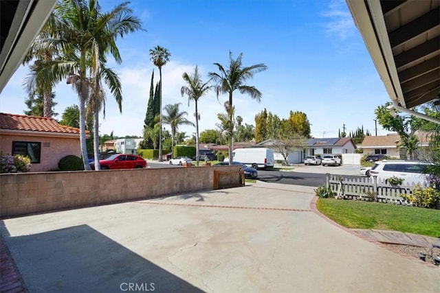 view of patio / terrace featuring fence and a residential view