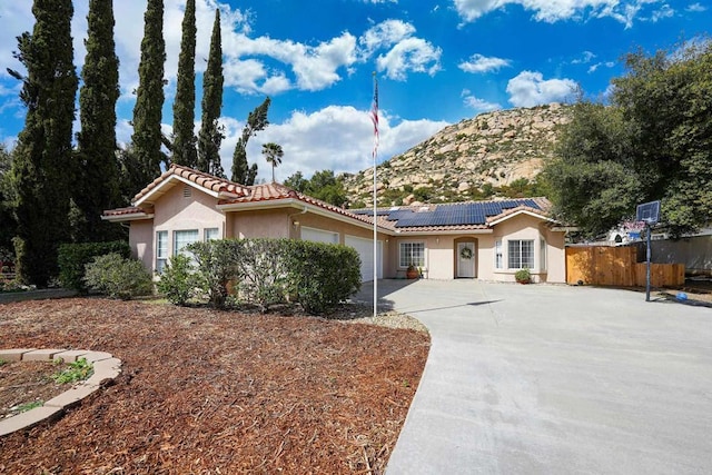 25318 Kerri Ln, Ramona, CA 92065 - view of front of house featuring a tile roof, concrete driveway, stucco siding, fence, and an attached garage