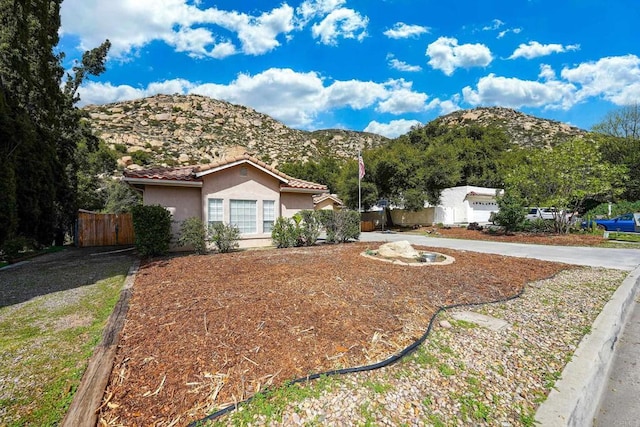 25318 Kerri Ln, Ramona, CA 92065 - view of front facade featuring a tile roof, stucco siding, a mountain view, and fence
