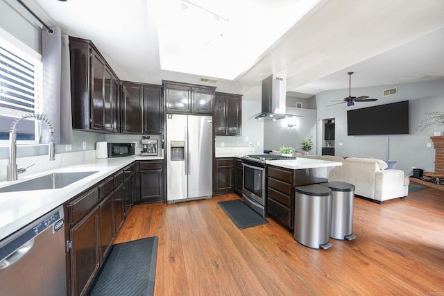 25318 Kerri Ln, Ramona, CA 92065 - kitchen with visible vents, a ceiling fan, appliances with stainless steel finishes, a sink, and ventilation hood