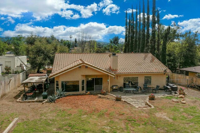 25318 Kerri Ln, Ramona, CA 92065 - rear view of property featuring a fenced backyard, a tiled roof, stucco siding, and a patio