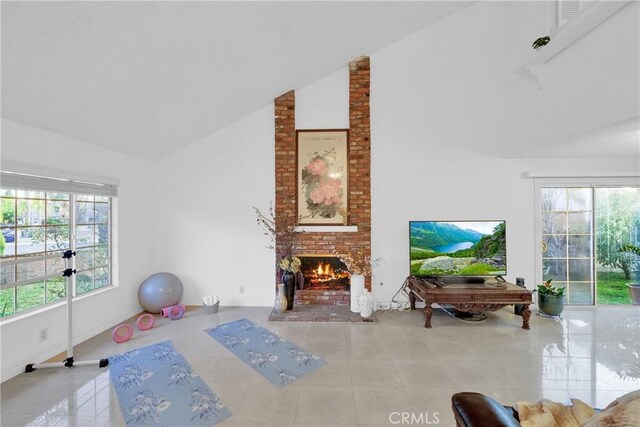 tiled living area with a brick fireplace, high vaulted ceiling, and a wealth of natural light