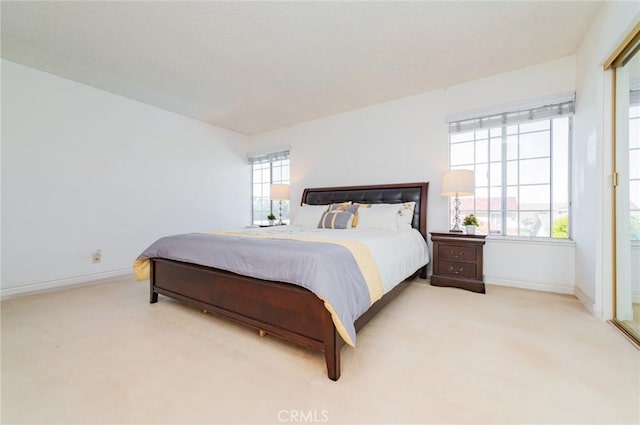 bedroom featuring baseboards and carpet