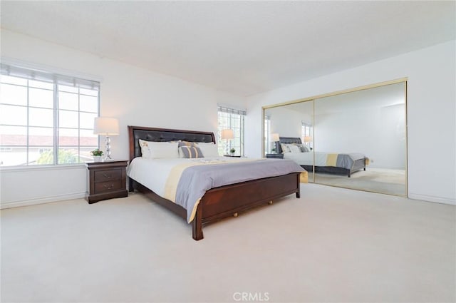 bedroom featuring a closet, multiple windows, and carpet