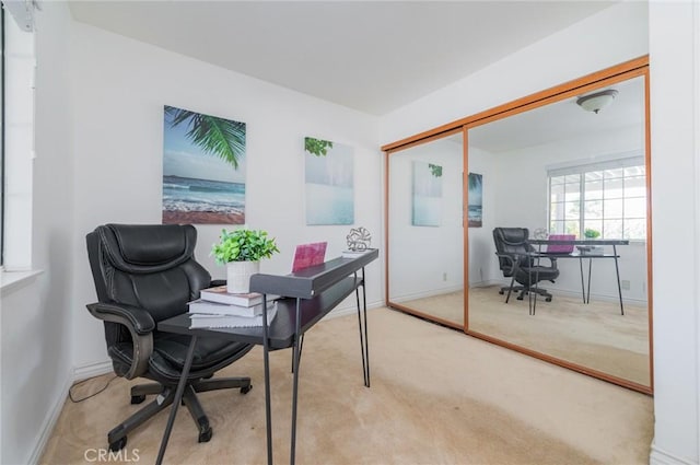 carpeted home office featuring baseboards