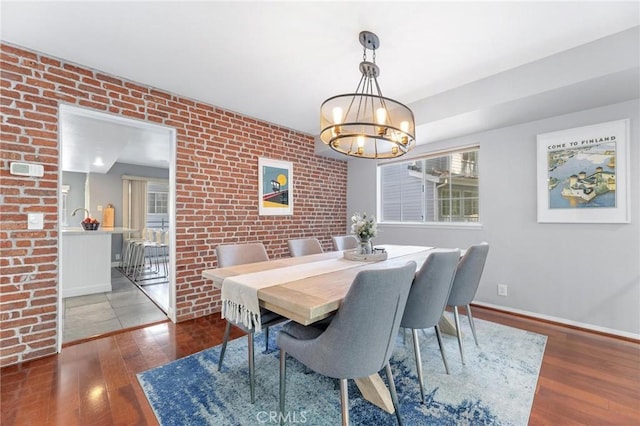 23163 Mulholland Dr Unit 6, Woodland Hills, CA 91364 - dining space with hardwood / wood-style floors, a chandelier, and brick wall