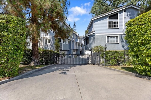 23163 Mulholland Dr Unit 6, Woodland Hills, CA 91364 - view of front of property featuring a gate, stucco siding, and a residential view
