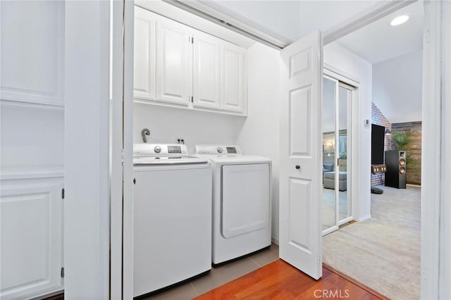 23163 Mulholland Dr Unit 6, Woodland Hills, CA 91364 - washroom with cabinet space, separate washer and dryer, and light wood-type flooring