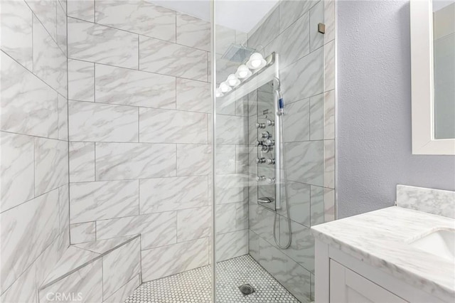 23163 Mulholland Dr Unit 6, Woodland Hills, CA 91364 - bathroom featuring vanity, tiled shower, and a textured wall