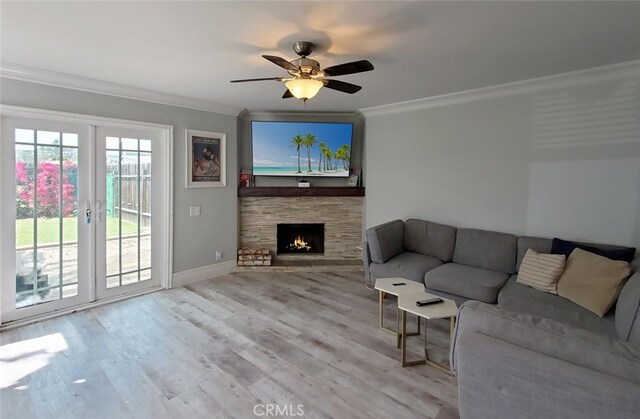 2512 Santa Ana Ave Unit 9, Costa Mesa, CA 92627 - living room with crown molding, a ceiling fan, wood finished floors, a stone fireplace, and baseboards
