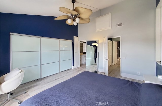 2512 Santa Ana Ave Unit 9, Costa Mesa, CA 92627 - unfurnished bedroom featuring a towering ceiling, wood finished floors, baseboards, ensuite bathroom, and ceiling fan