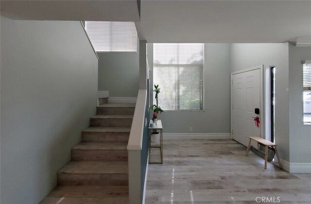 2512 Santa Ana Ave Unit 9, Costa Mesa, CA 92627 - foyer with stairs, light wood-style floors, and baseboards