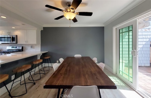 2512 Santa Ana Ave Unit 9, Costa Mesa, CA 92627 - dining room with light wood finished floors, ornamental molding, a ceiling fan, and baseboards