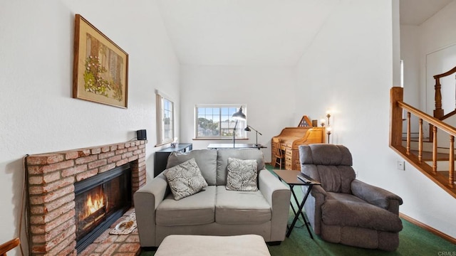 living room featuring lofted ceiling, a brick fireplace, and stairs