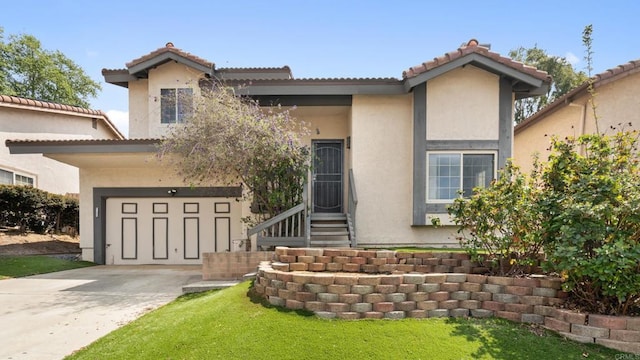 view of front of house with stucco siding, concrete driveway, and a tiled roof