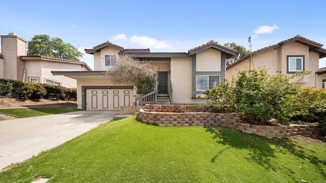 view of front facade with a garage, stucco siding, a front yard, and concrete driveway