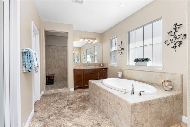 34595 Collier Falls Ct, Temecula, CA 92592 - full bathroom featuring vanity, a garden tub, plenty of natural light, and a tile shower