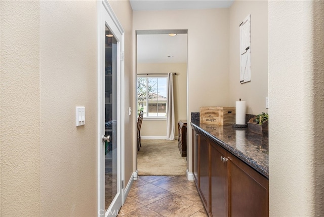 34595 Collier Falls Ct, Temecula, CA 92592 - corridor with light tile patterned floors, light colored carpet, and a textured wall