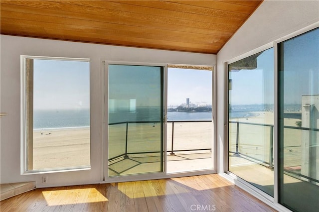 unfurnished sunroom featuring a water view