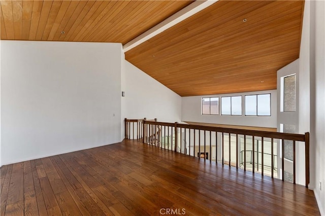 empty room featuring hardwood / wood-style floors, wood ceiling, and high vaulted ceiling