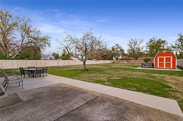 295 Chestnut Ave, Red Bluff, CA 96080 - view of yard with a patio area, an outdoor structure, a storage shed, a fenced backyard, and outdoor dining area