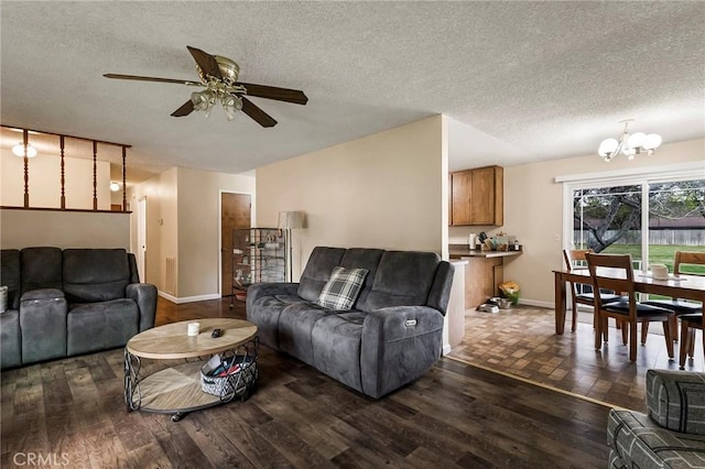 295 Chestnut Ave, Red Bluff, CA 96080 - living room with dark wood-style flooring, ceiling fan with notable chandelier, baseboards, and a textured ceiling
