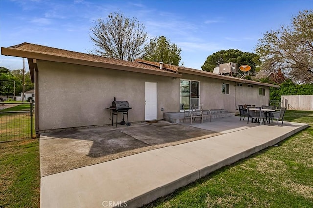 295 Chestnut Ave, Red Bluff, CA 96080 - back of property with a patio, stucco siding, fence, and a yard