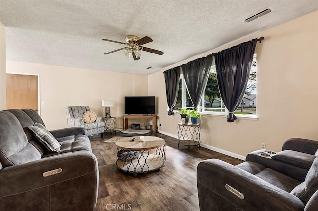295 Chestnut Ave, Red Bluff, CA 96080 - living room with a textured ceiling, visible vents, baseboards, ceiling fan, and dark wood-type flooring