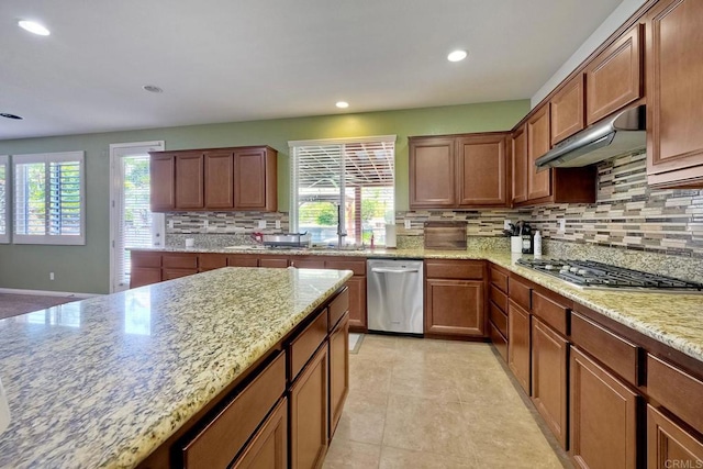 1140 Parkview Dr, Oceanside, CA 92057 - kitchen featuring appliances with stainless steel finishes, backsplash, recessed lighting, under cabinet range hood, and light stone counters
