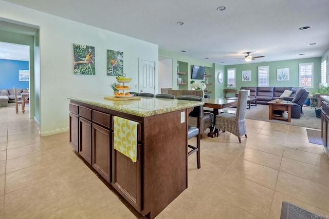 1140 Parkview Dr, Oceanside, CA 92057 - kitchen featuring a kitchen breakfast bar, open floor plan, a ceiling fan, and light tile patterned flooring
