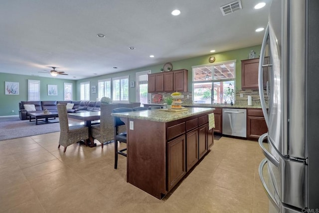 1140 Parkview Dr, Oceanside, CA 92057 - kitchen featuring stainless steel appliances, a kitchen bar, recessed lighting, healthy amount of natural light, and open floor plan