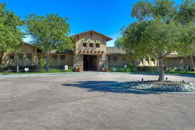 1140 Parkview Dr, Oceanside, CA 92057 - mediterranean / spanish-style home featuring stucco siding, stone siding, a tile roof, and curved driveway