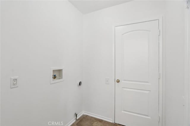 clothes washing area featuring baseboards, washer hookup, and laundry area