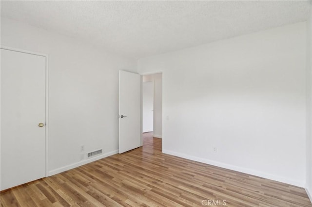 interior space featuring visible vents, baseboards, and light wood-type flooring