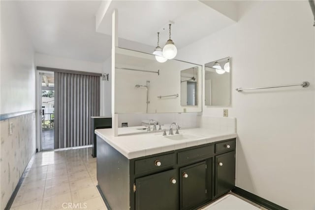 bathroom featuring tile patterned floors, vanity, and baseboards