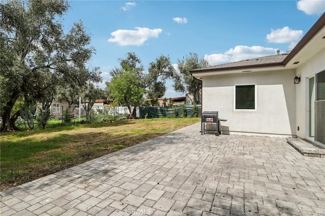 view of patio featuring fence and grilling area