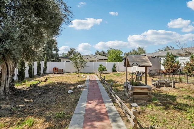view of yard featuring a fenced backyard and a garden