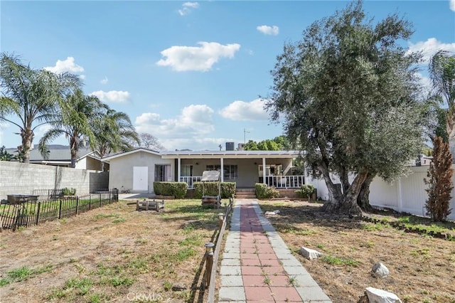 single story home featuring a porch, stucco siding, and fence