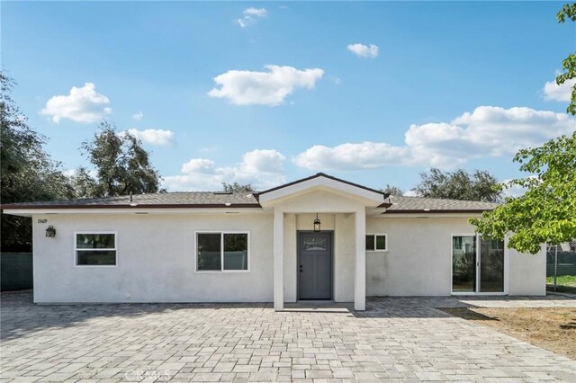 ranch-style house with a patio and stucco siding