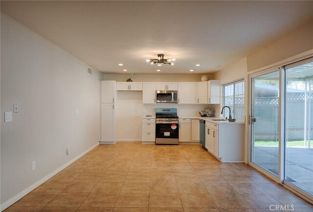 kitchen with white cabinetry, recessed lighting, a sink, and stainless steel appliances