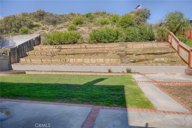 view of yard with a garden and a fenced backyard