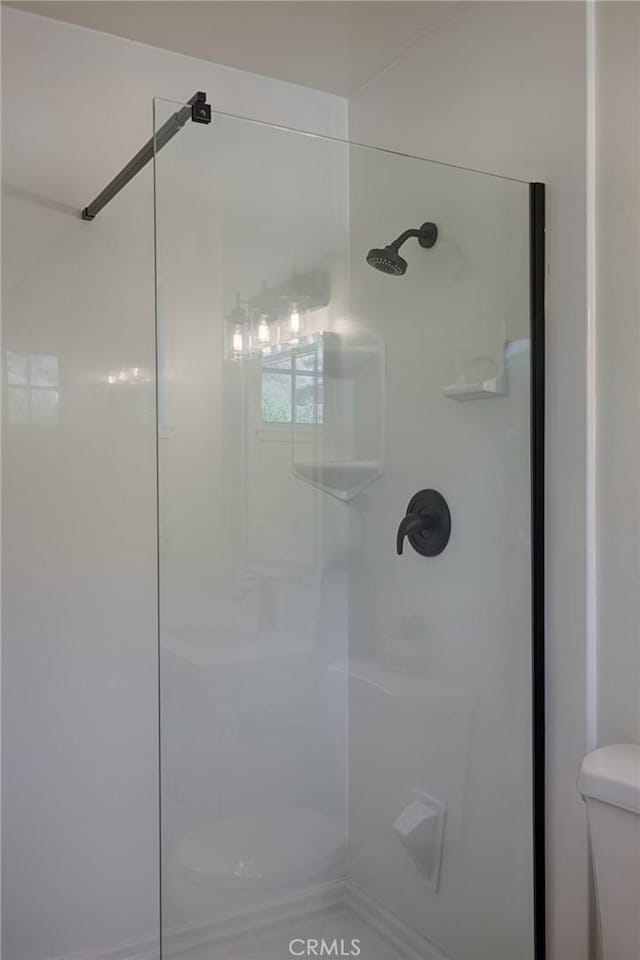 full bathroom with toilet and walk in shower